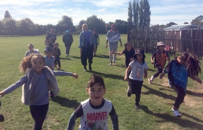 Students from Te Pa o Rākaihautū running across a playground.